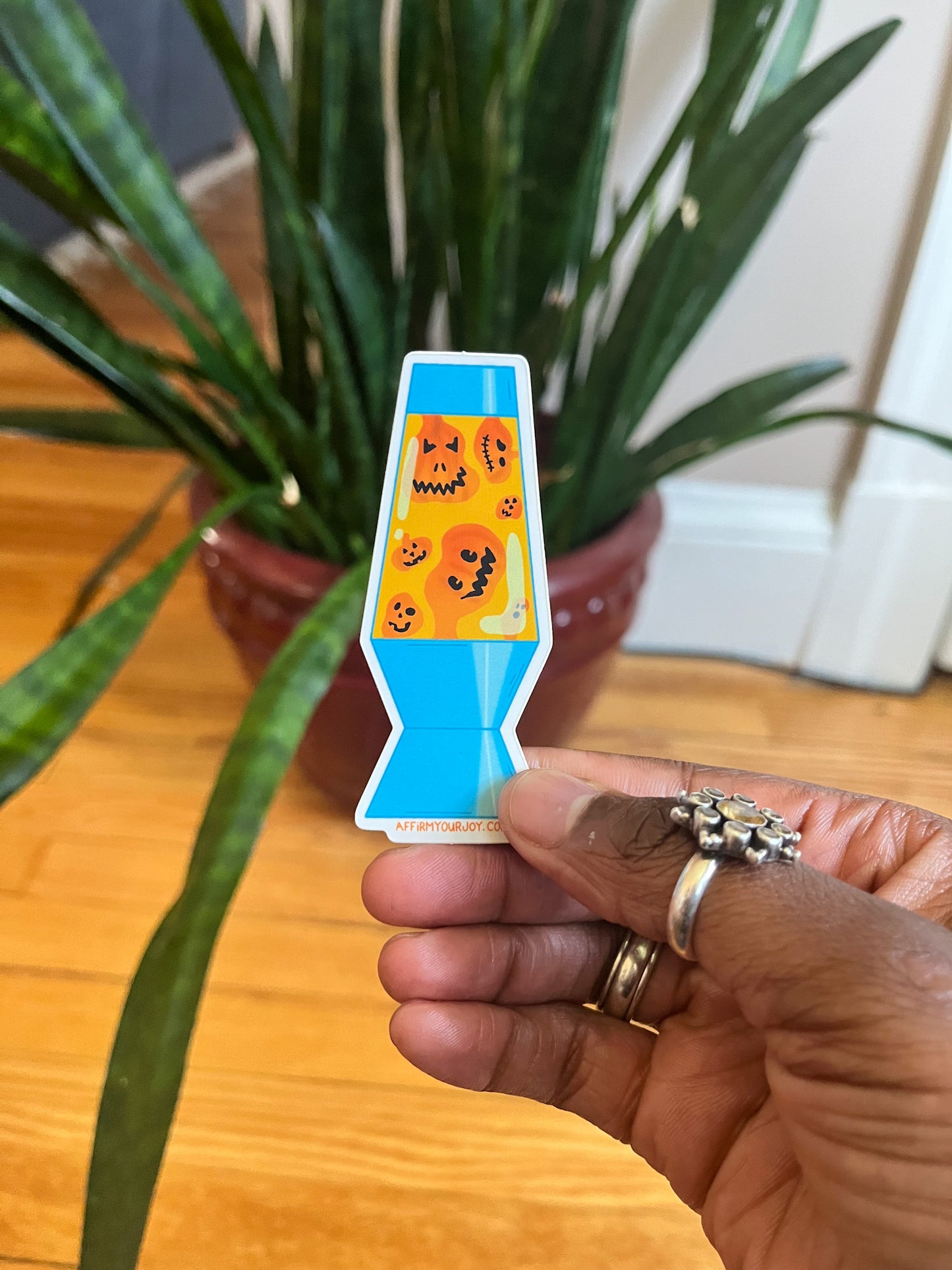 Pumpkin Lava Lamp vinyl sticker. Light blue lava lamp with orange jack-o-lantern pumpkins floating inside