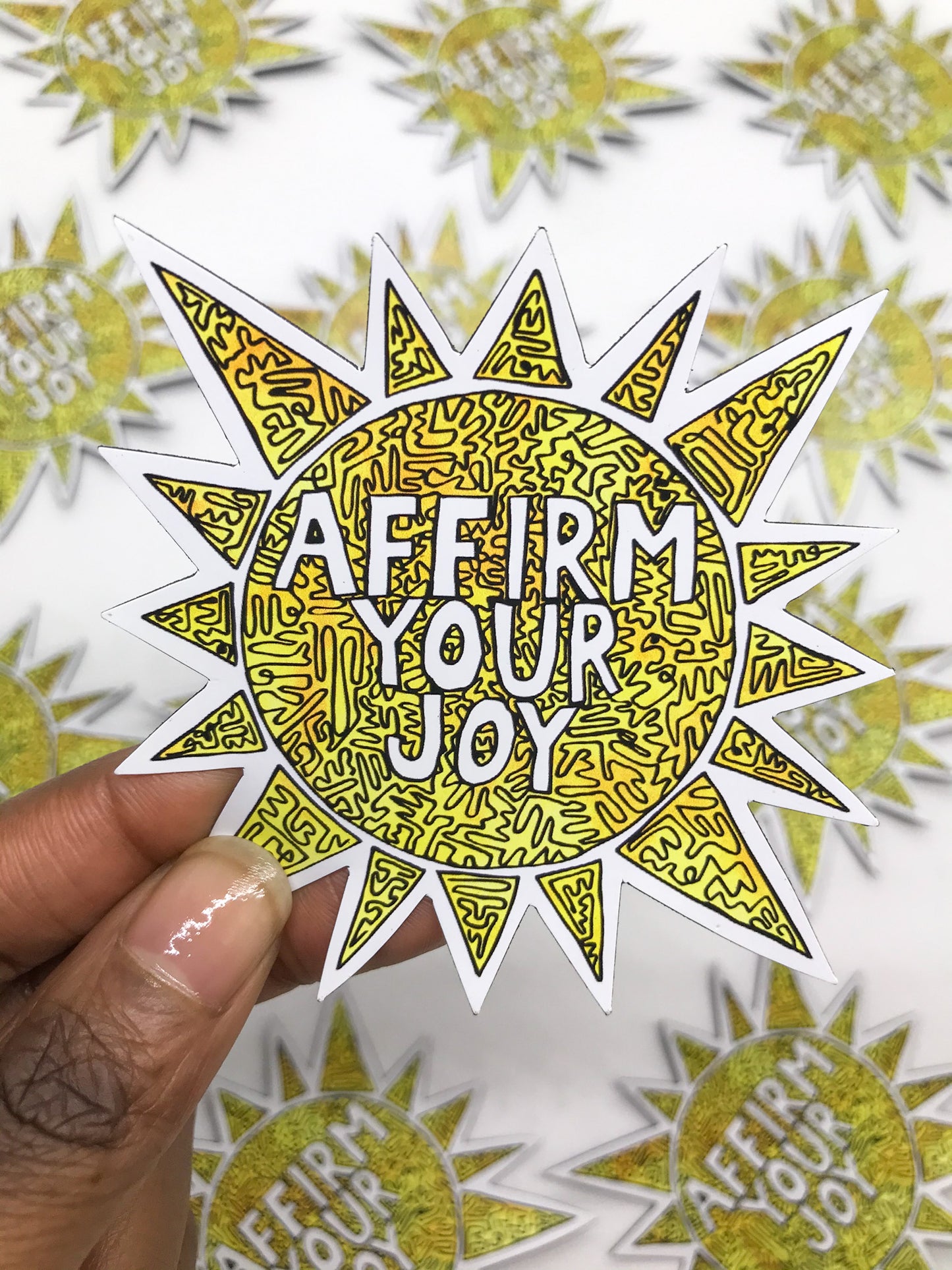 Affirm Your Joy Sun Magnet. Yellow sun with black line design throughout. Magnet reads: AFFIRM YOUR JOY