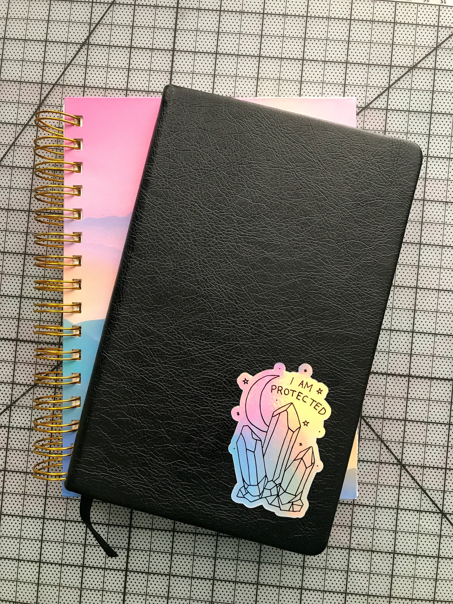 "I Am Protected" holographic sticker on journal cover